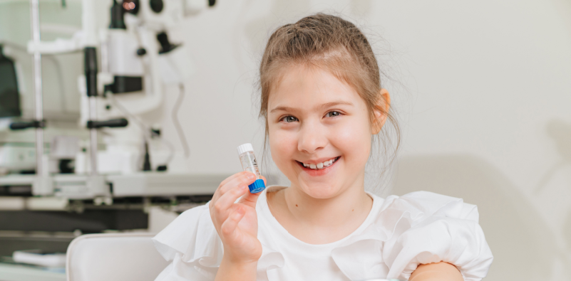 Young girl with ortho-k lenses for childhood myopia management and vision correction.]