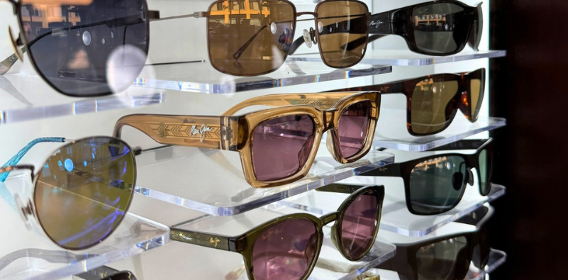 A close-up of various Maui Jim sunglasses on a shelf.