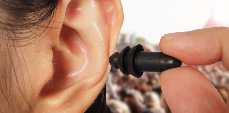 An earplug being inserted into an ear for hearing protection