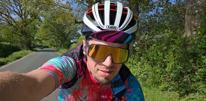 Cyclist wearing sports sunglasses on a country road