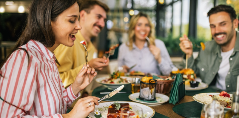 Group of friends eating together in a restaurant