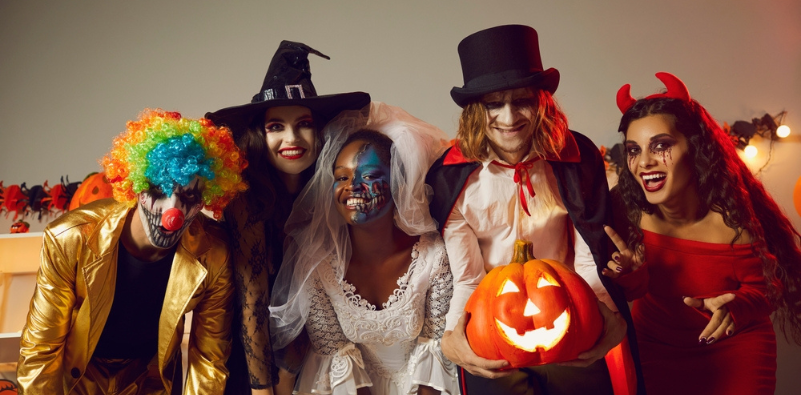 A group of friends in Halloween costumes and make-up at a party